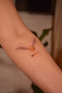 Fine line celestial hand tattoo featuring stars, crescent moon, and dainty dots