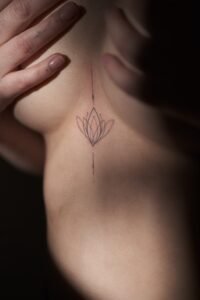 Micro color realism autumn maple leaf tattoo in orange and yellow on inner arm