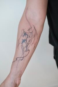 Fine line celestial hand tattoo featuring stars, crescent moon, and dainty dots