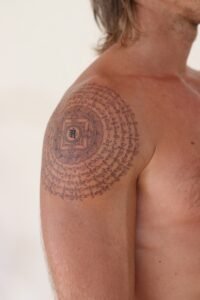 Fine line celestial hand tattoo featuring stars, crescent moon, and dainty dots