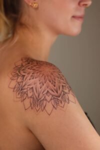 Intricate geometric mandala shoulder tattoo with dotwork and fine line details at Names Tattoo Studio in Lisbon