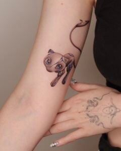 Micro color realism Monstera leaf tattoo with green and red variegation on inner forearm