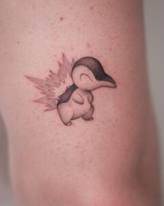 Micro color realism Monstera leaf tattoo with green and red variegation on inner forearm