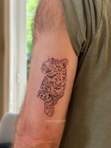 Micro color realism autumn maple leaf tattoo in orange and yellow on inner arm