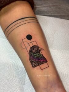 Blue ink ornamental tattoo inspired by azulejo Portuguese tile patterns, featuring a symmetrical diamond-shaped design with intricate fine-line scrolls and floral motifs on the skin