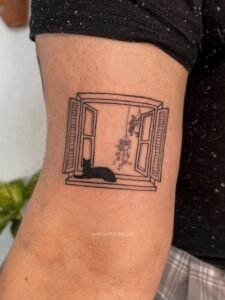 A fine-line Sanskrit script tattoo on the forearm featuring an Om symbol inside a sunburst, a blooming lotus flower, and delicate ornamental swirls, crafted at Names Tattoo Studio in Lisbon