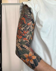 Traditional Japanese Irezumi sleeve tattoo with fox and flowers