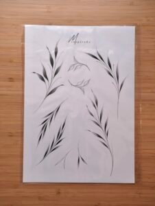 A minimalist tattoo flash sheet featuring a variety of elegant botanical branches