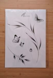 A minimalist tattoo flash sheet featuring delicate butterflies, a ladybug