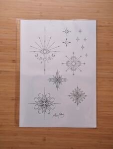Fine-line celestial tattoo flash sheet featuring mystical eye with moon phases