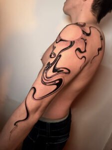 Abstract fluid marble flow tattoo in black ink on shoulder and full arm
