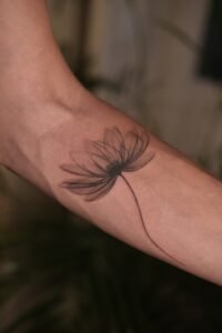 Fine line celestial hand tattoo featuring stars, crescent moon, and dainty dots