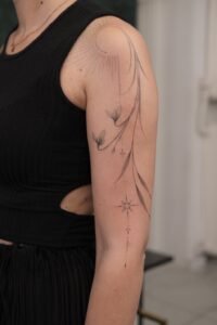 Fine line red Japanese characters handpoke tattoo on the arm