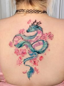 Micro color realism Monstera leaf tattoo with green and red variegation on inner forearm