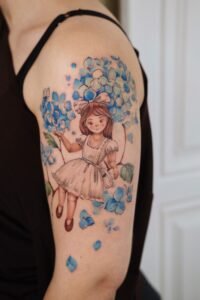 Small fineline skull tattoo with floral mandala detail on thigh