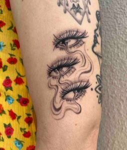 Nessi eyes arm tattoo