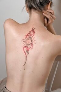 A fine-line Sanskrit script tattoo on the forearm featuring an Om symbol inside a sunburst, a blooming lotus flower, and delicate ornamental swirls, crafted at Names Tattoo Studio in Lisbon