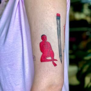 A surreal black and grey micro-realism tattoo on a leg featuring an Arowana fish spiraling around a vertical needle, complemented by abstract geometric shards at the top