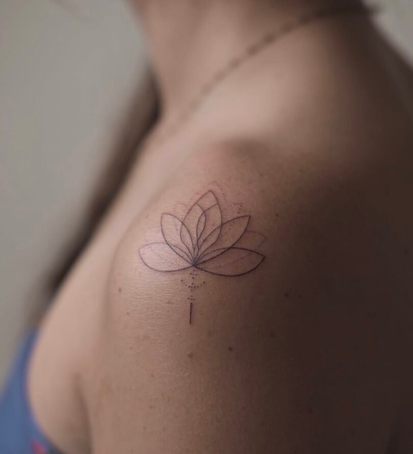 Geometric fine line flower handpoke tattoo on the shoulder